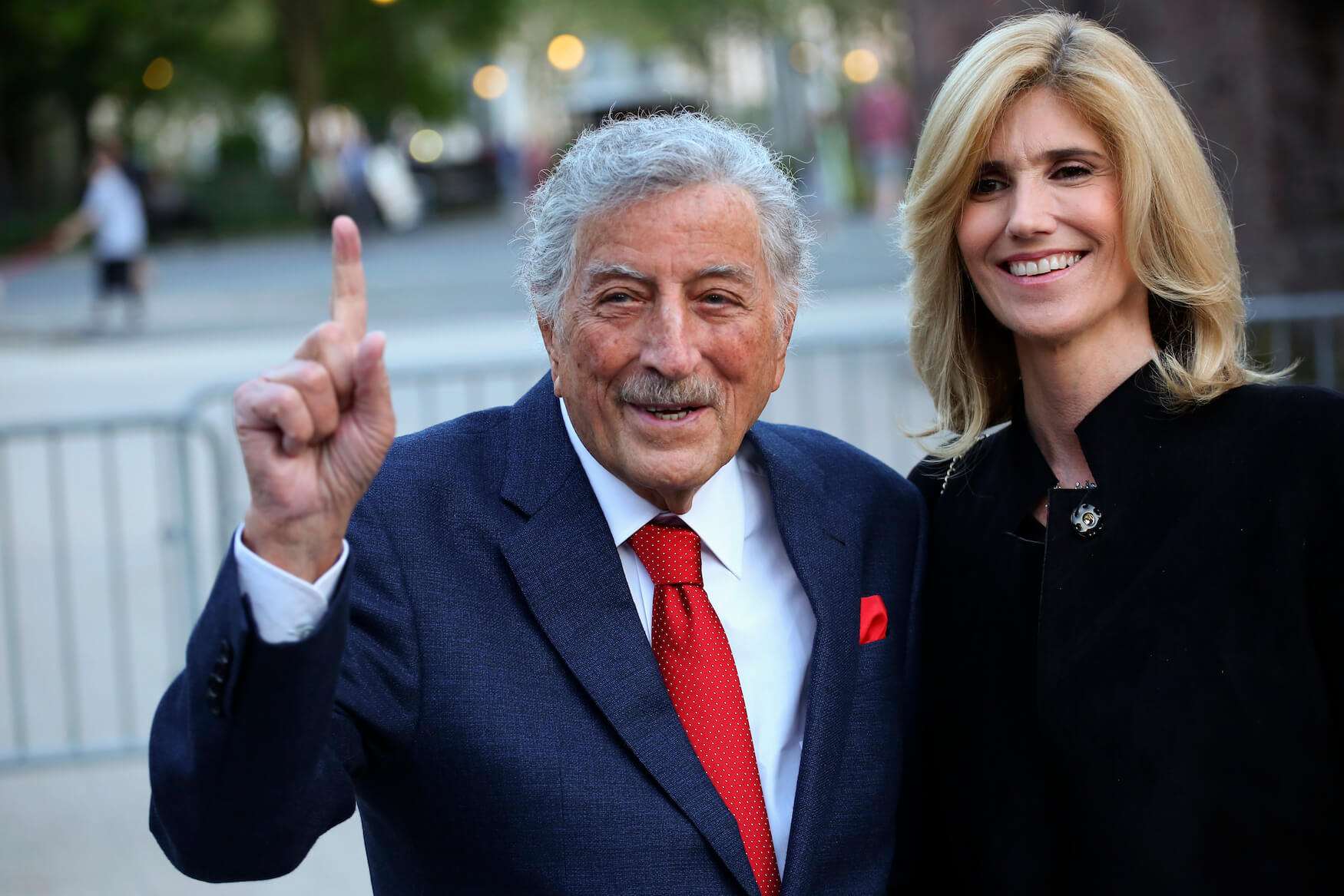 Tony Bennett and his wife, Susan Benedetto, standing together and smiling outdoors