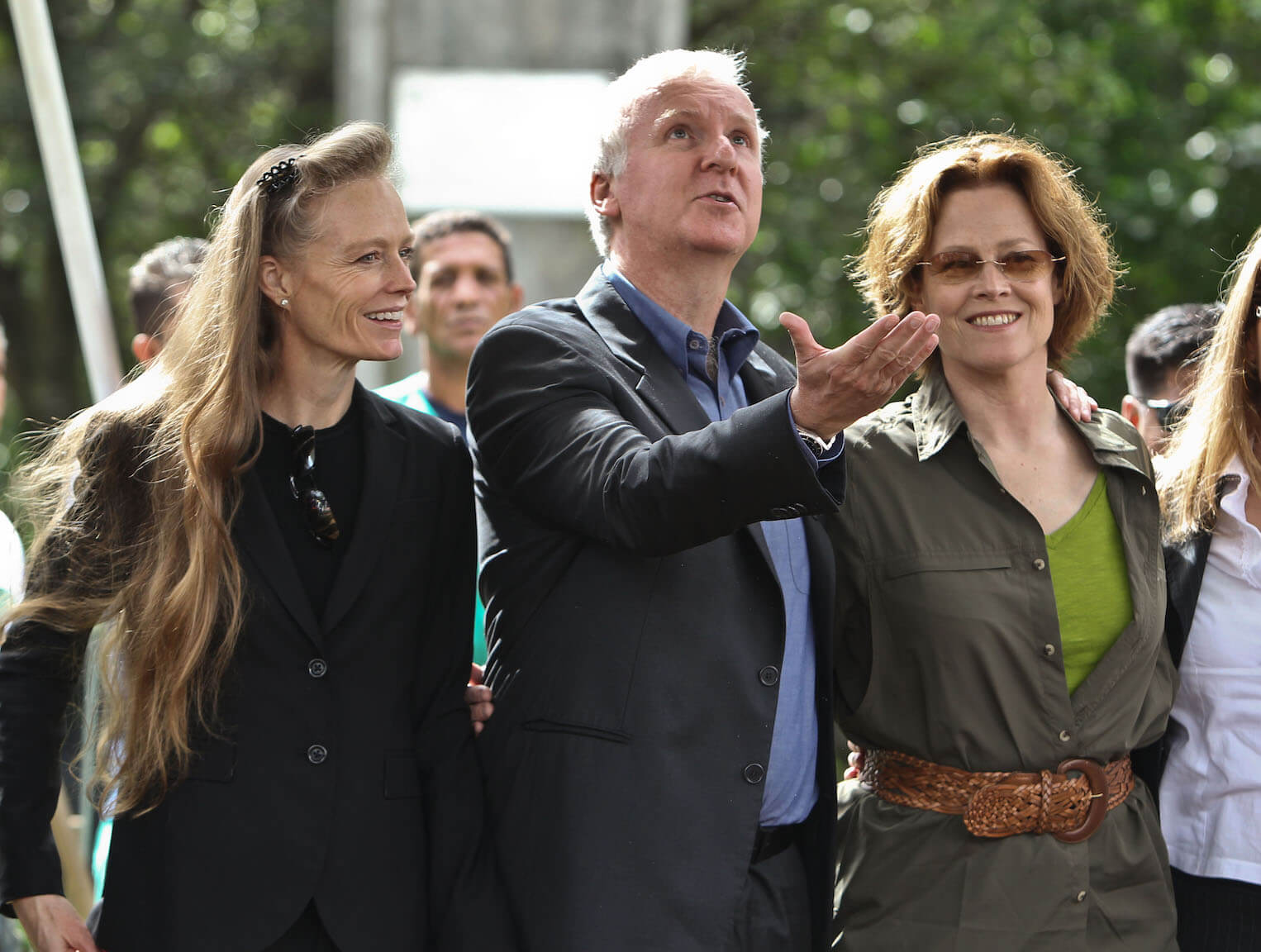 'Avatar 3' director James Cameron holding his hand out and looking at something above him with his wife, Suzy Amis, and actor Sigourney Weaver