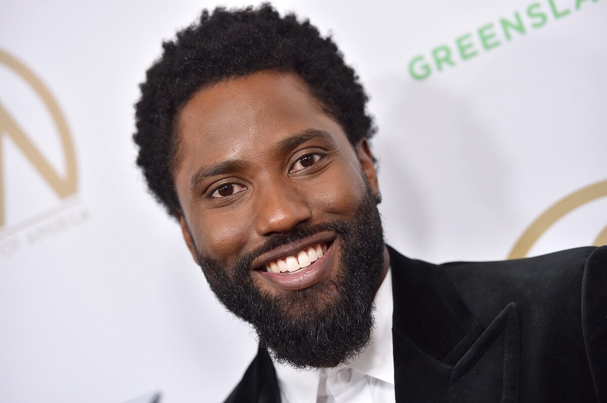 John David Washington taking a picture in a suit at the 30th Annual Producers Guild Awards.