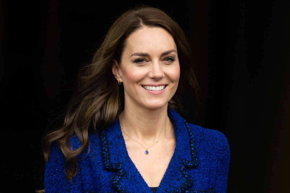 Kate Middleton, who has a 'regimented life plan,' according to an expert, smiles wearing a blue blazer