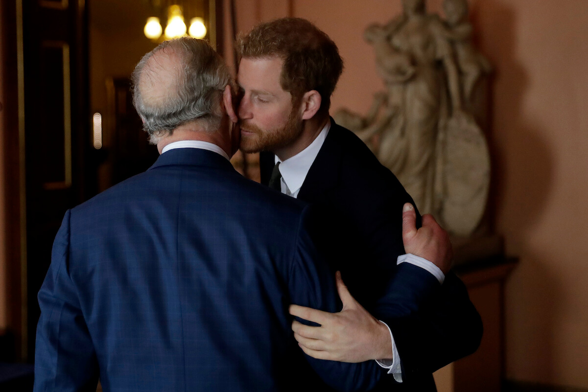 Prince Harry kisses his father, King Charles, in 2018