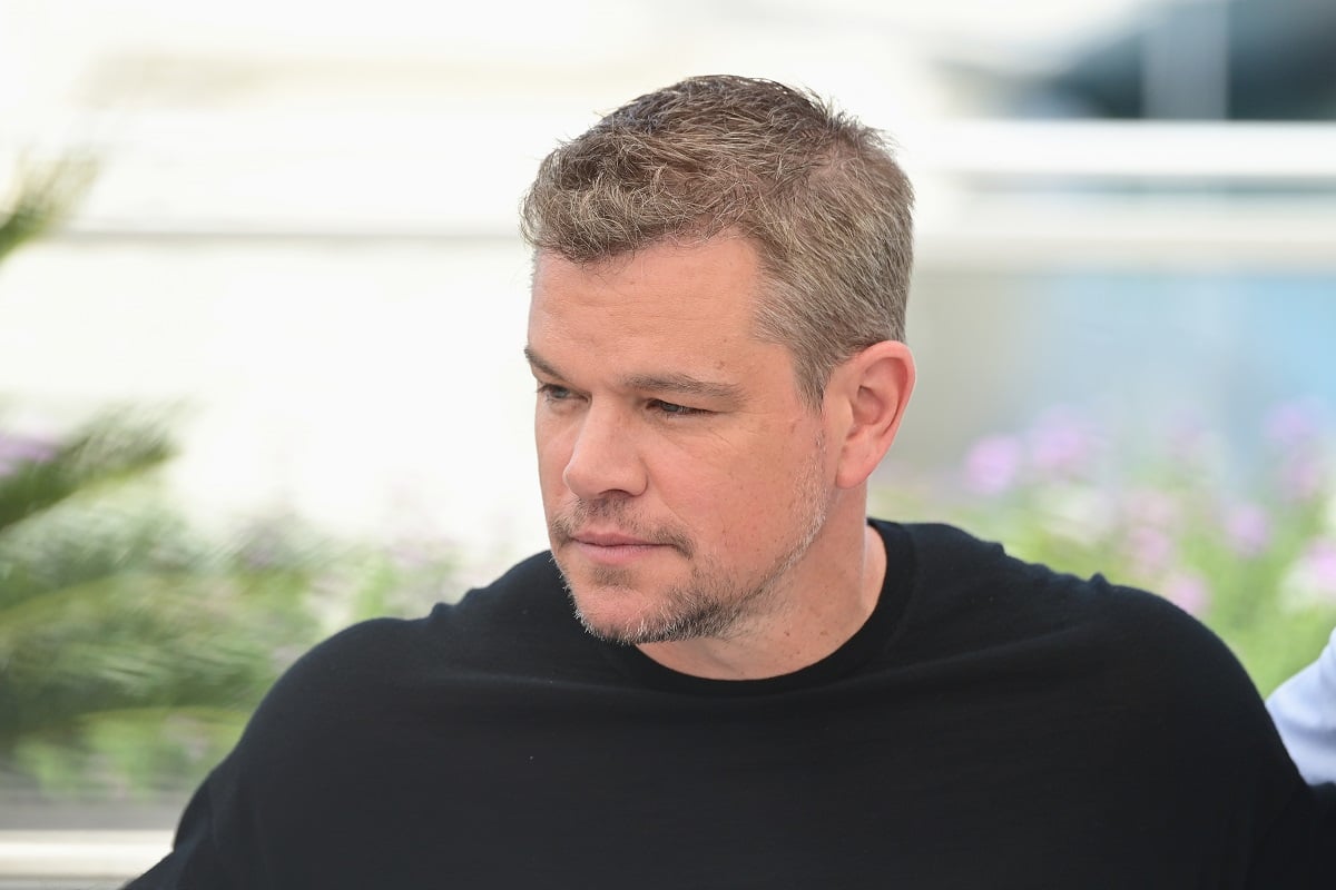 Matt Damon taking a picture at a photocall for 'StillWater' in a black shirt.