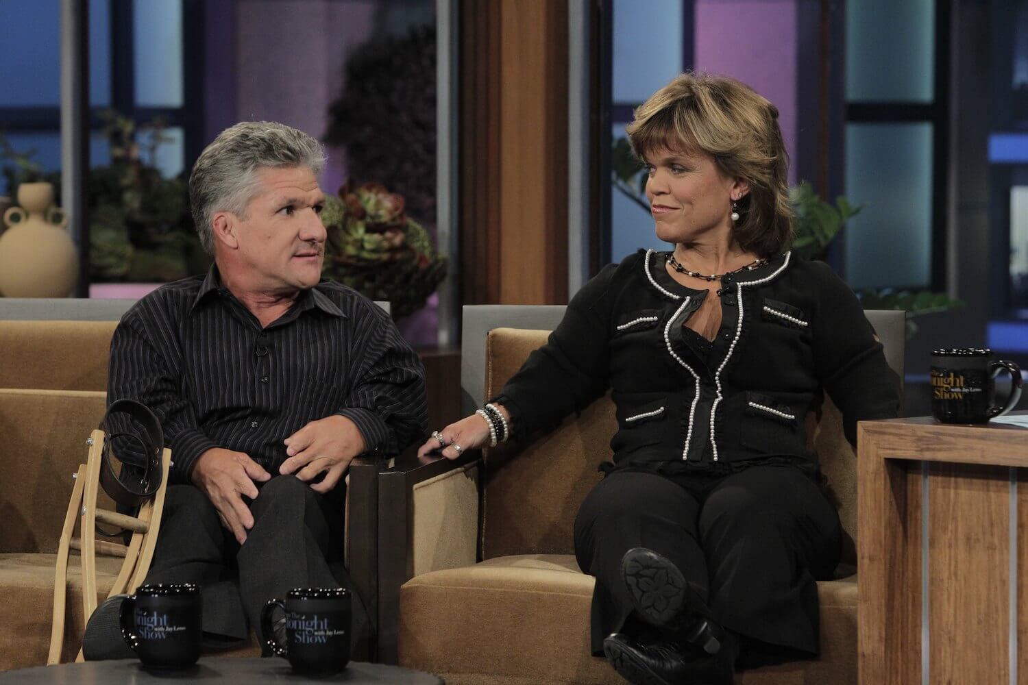 Matt and Amy Roloff from 'Little People, Big World' looking at each other while sitting on a sofa