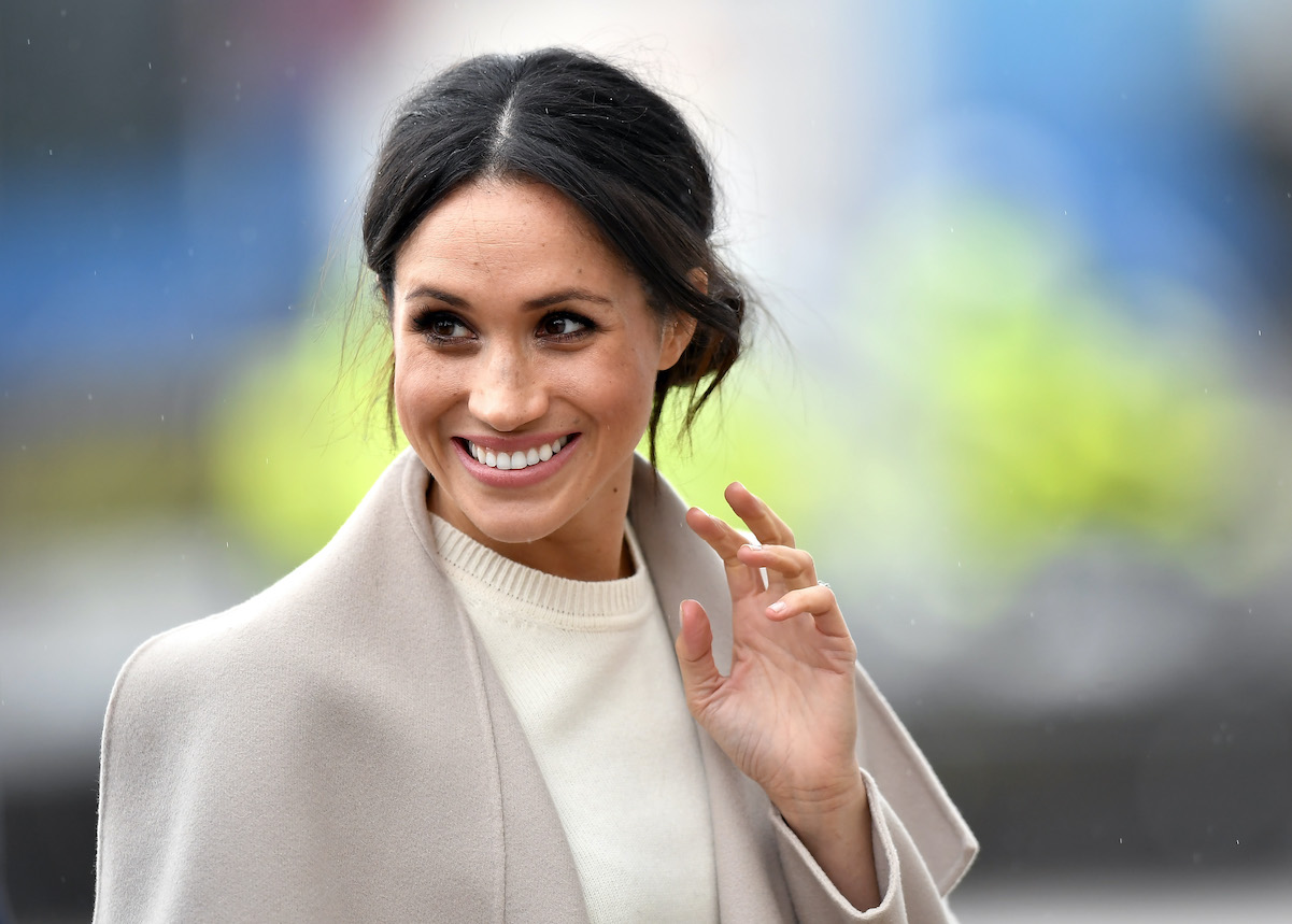 Meghan Markle smiling and waving.