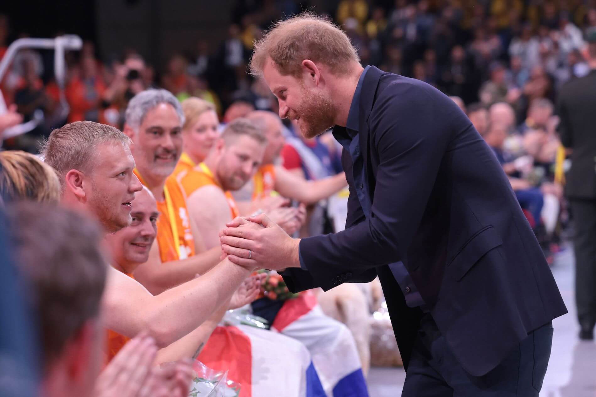 Prince Harry holding the hand of a competitor in the 2020 Invictus Games in the Netherlands