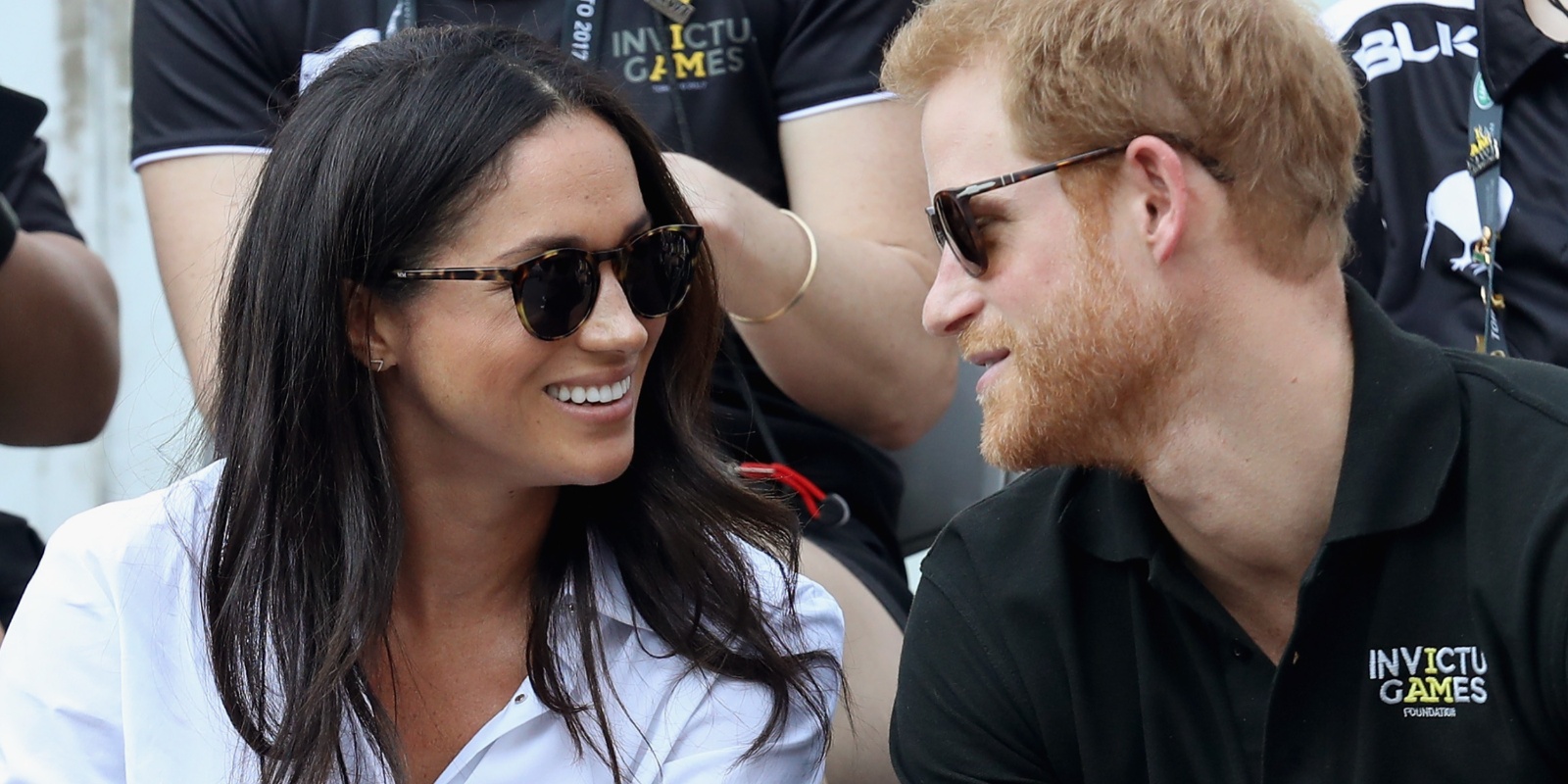 Meghan Markle and Prince Harry look at each other during their first public appearance in 2017.