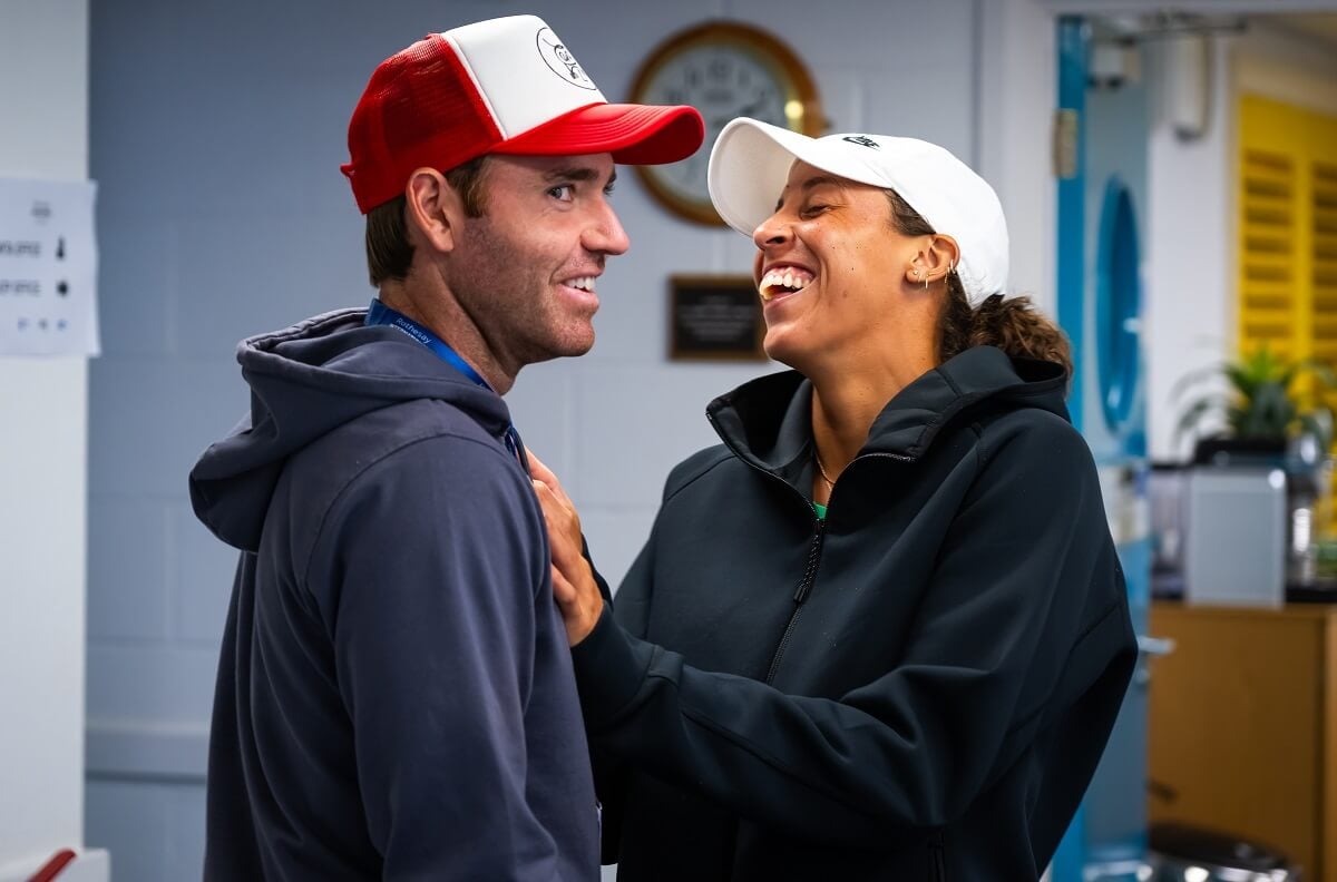 Madison Keys and fiancé Bjorn Fratangelo chatting and laughing during tennis match rain delay