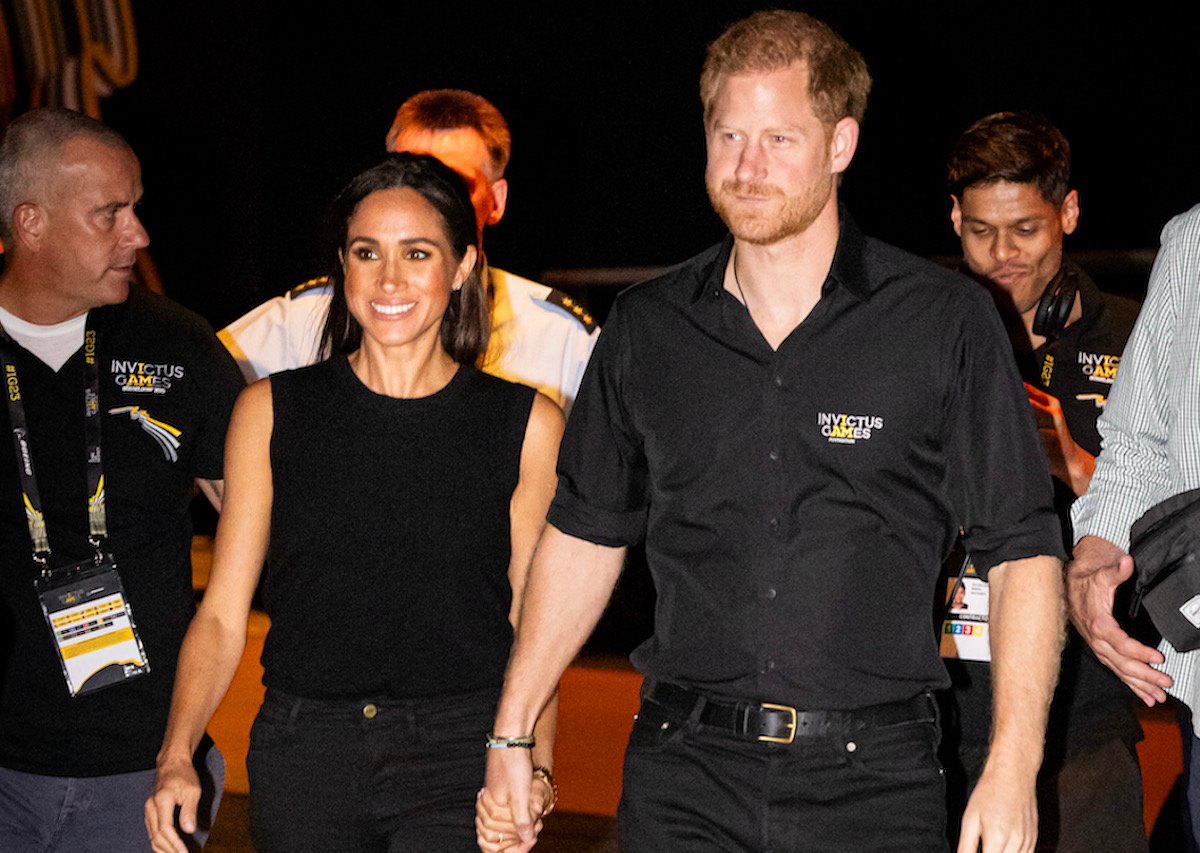 Meghan Markle and Prince Harry hold hands at the Invictus Games.