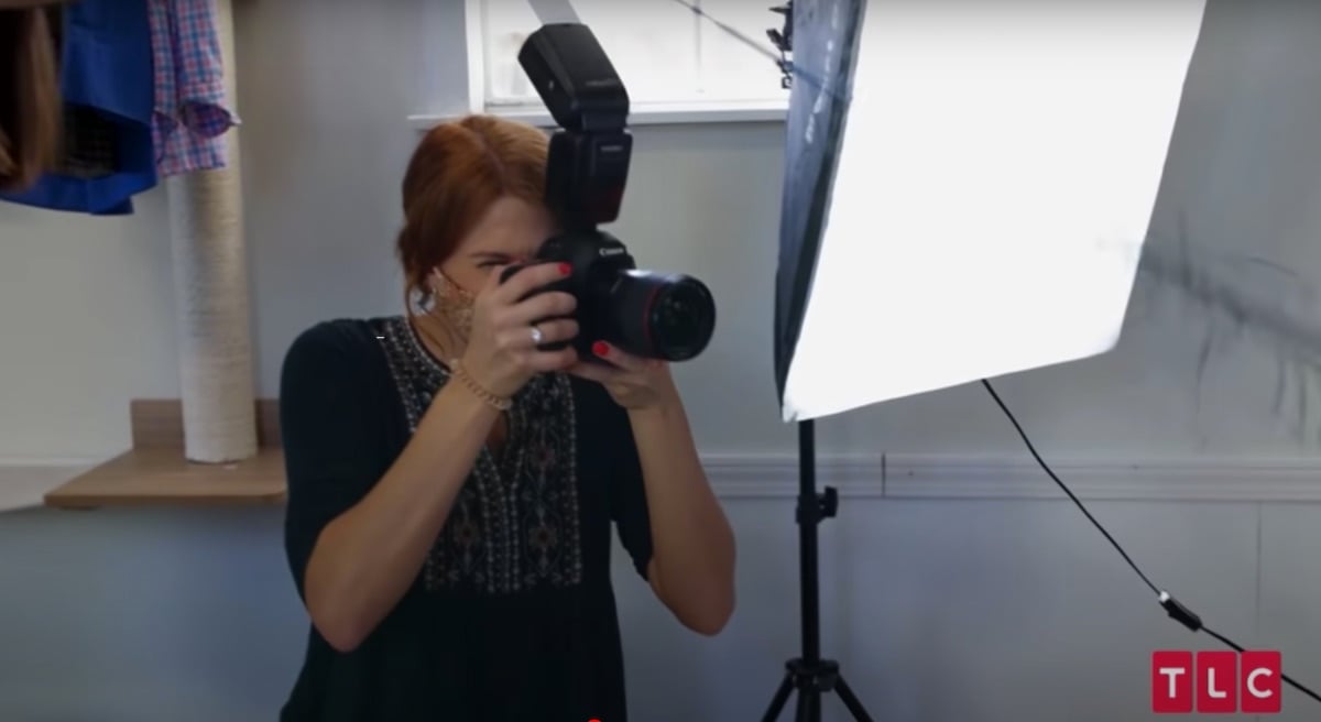 Olivia Plath holding a camera in 'Welcome to Plathville'