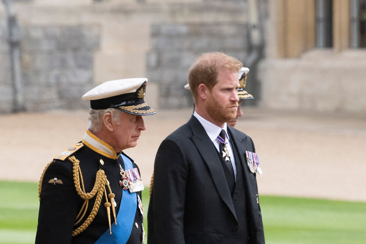 King Charles, who is 'subtly punishing' Prince Harry, walks with his son