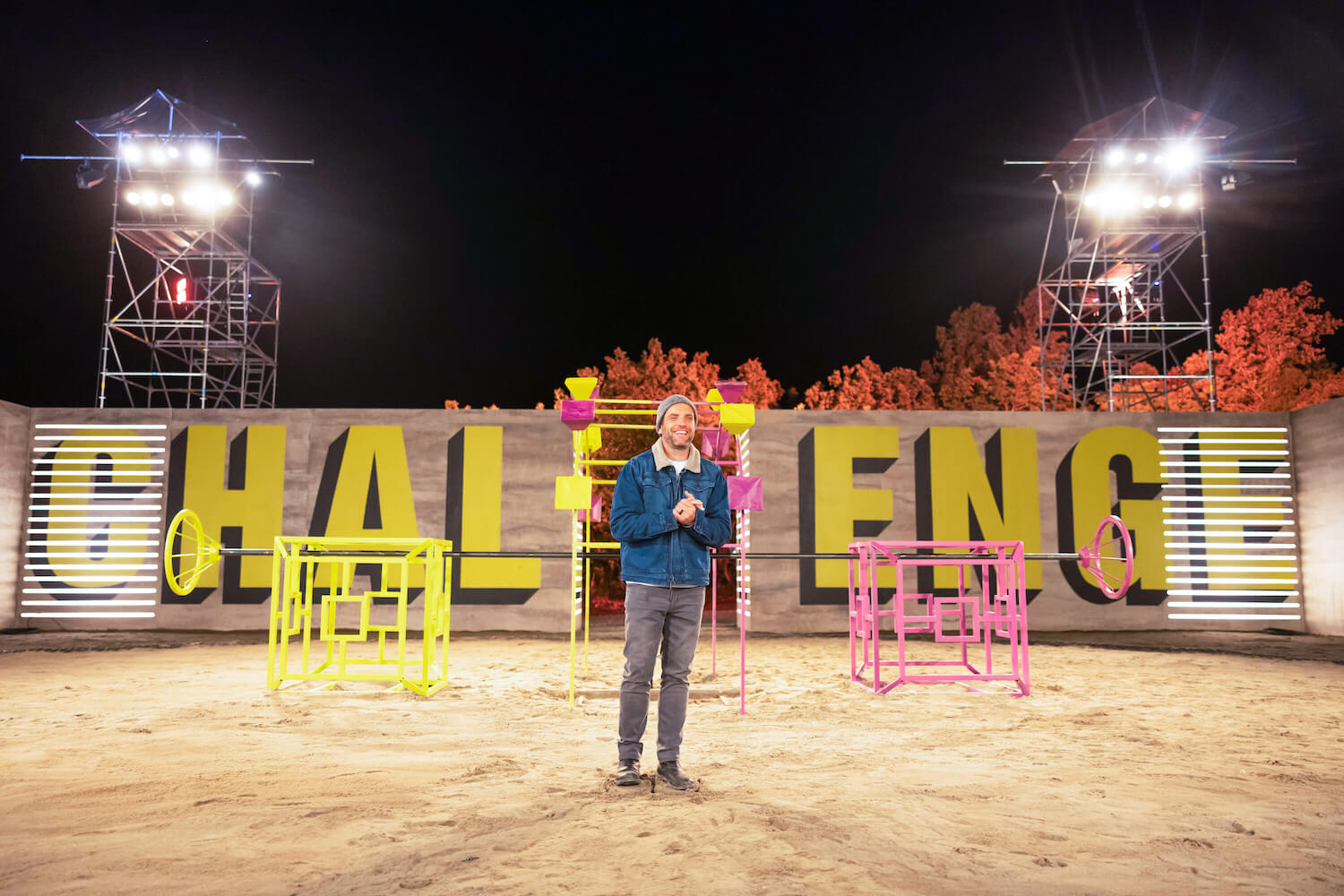 T.J. Lavin in front of 'The Challenge' sign before a challenge in 'The Challenge: USA' Season 2 Week 9 Episode 12