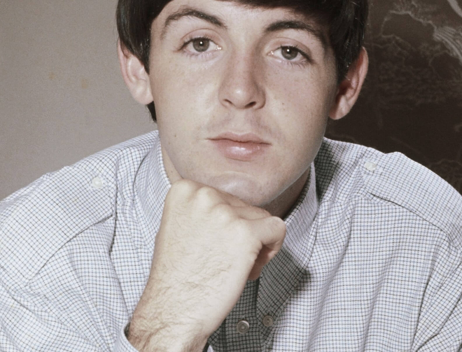 The Beatles' Paul McCartney with his head on his hand
