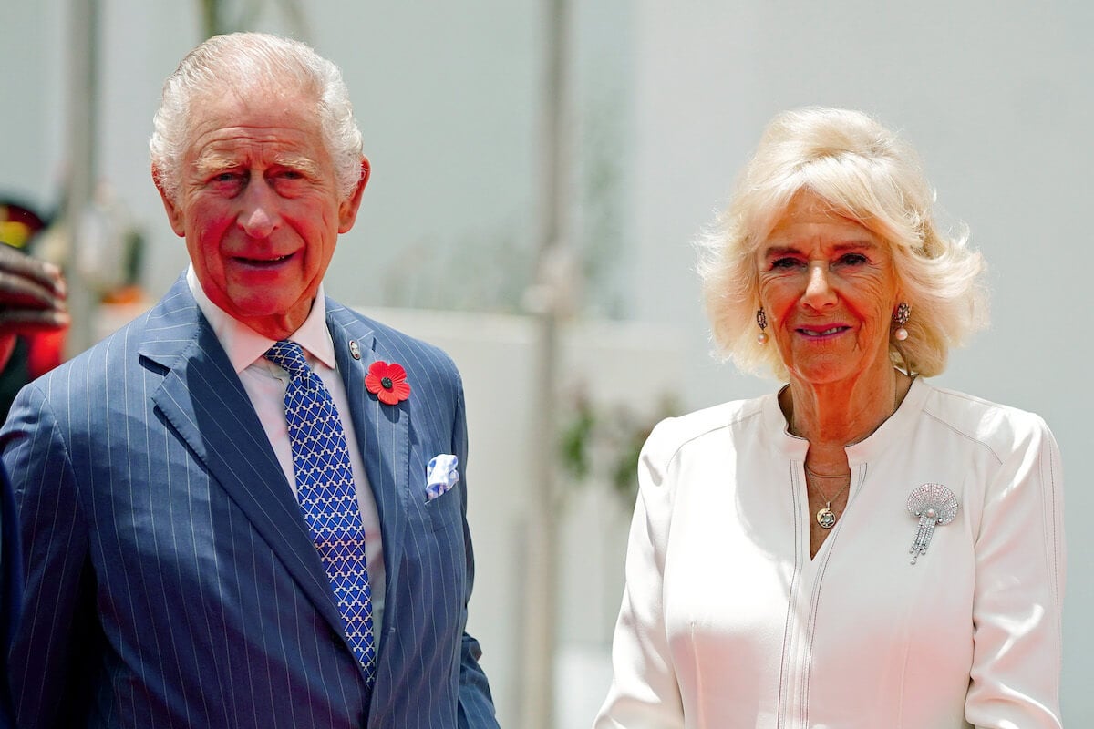 Queen Camilla, whose invitation to a 2004 wedding led King Charles to propose, stands with King Charles