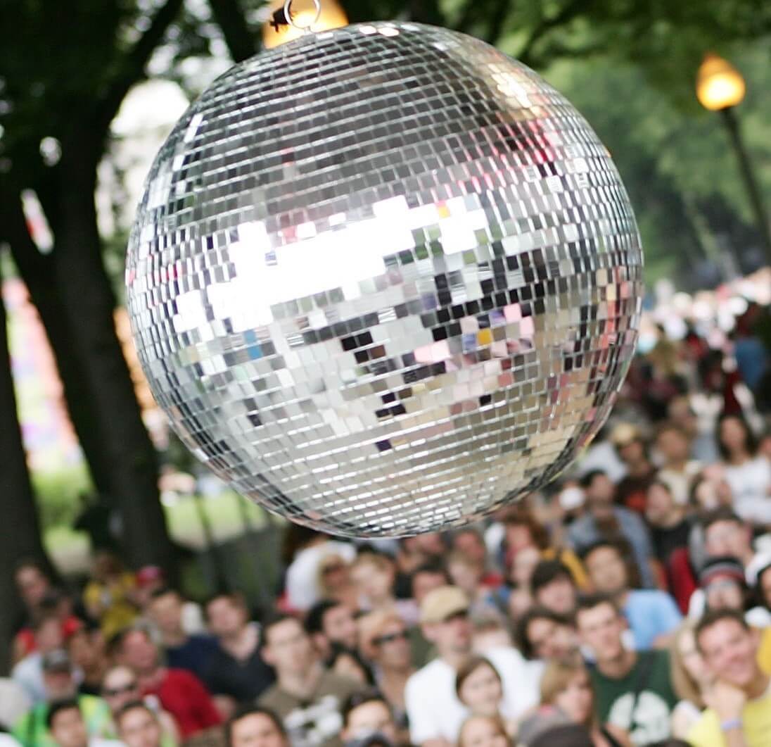 A disco ball in front of a crowd