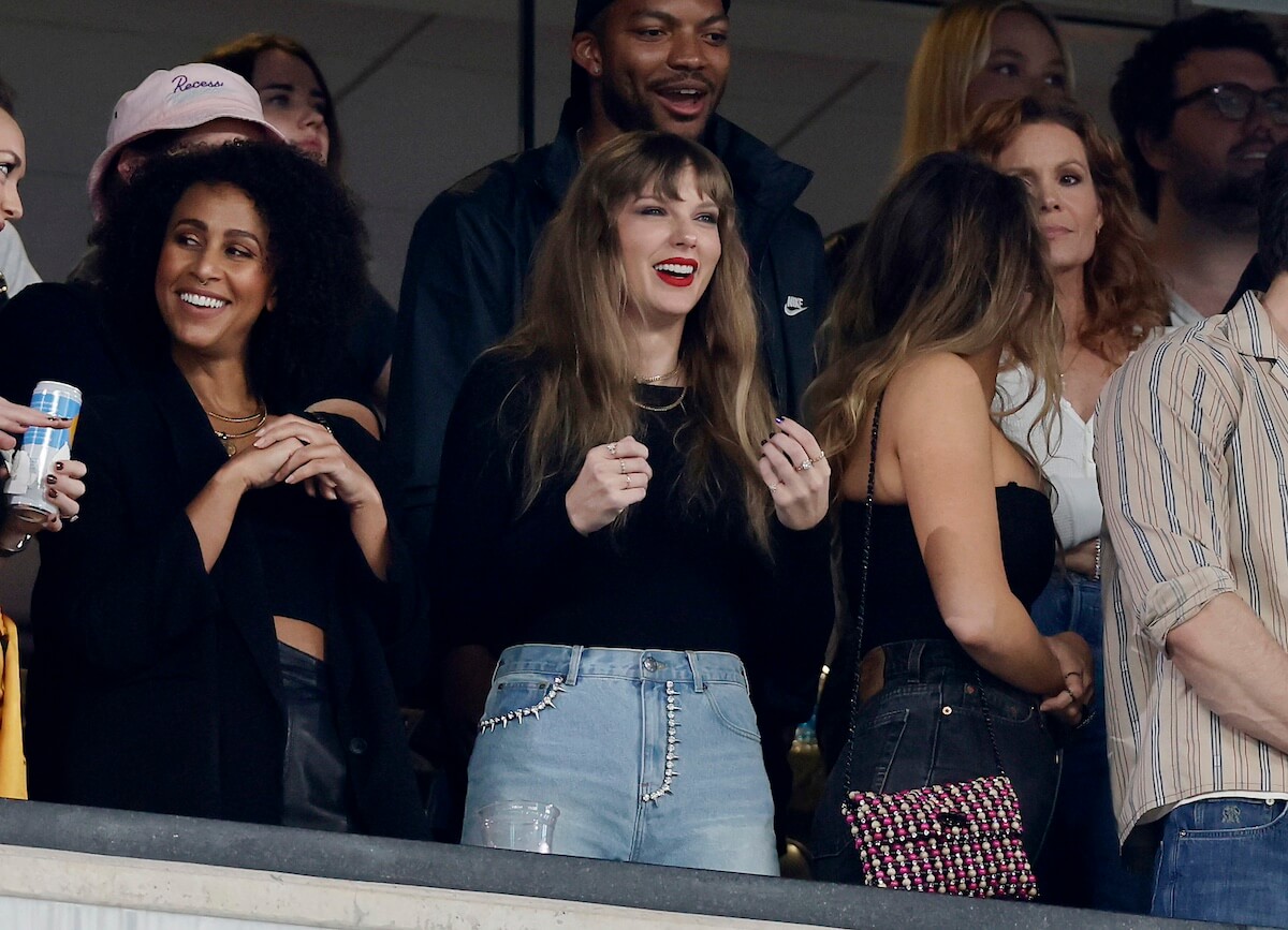 Taylor Swift, in black top, in a box at an NFL game