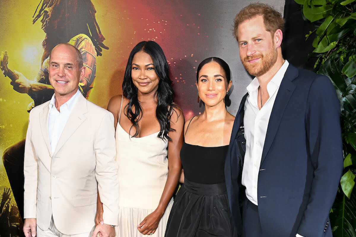 Meghan Markle and Prince Harry, who reminded the royal family they couldn't be trusted by attending the 'Bob Marley: One Love' premiere in Jamaica, stand with Brian and Tracy Robbins