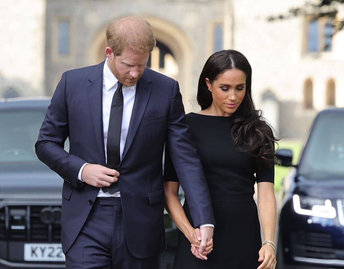 Prince Harry and Meghan Markle arrive on the Long Walk at Windsor Castle arrive to view flowers and tributes to Queen Elizabeth II