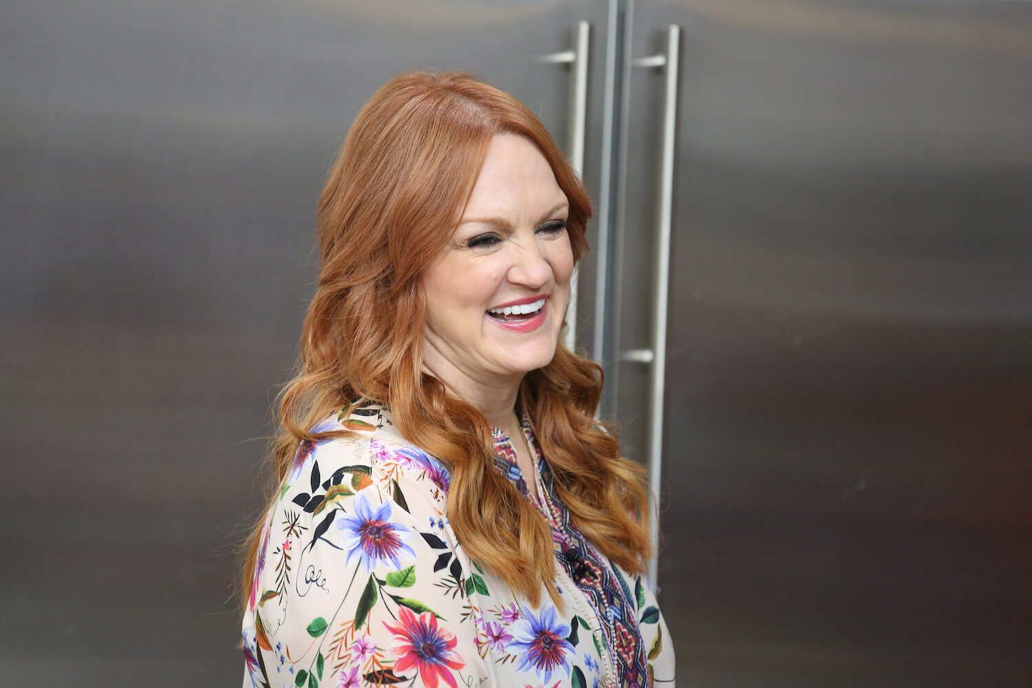 A close-up of 'The Pioneer Woman' Ree Drummond laughing in a kitchen