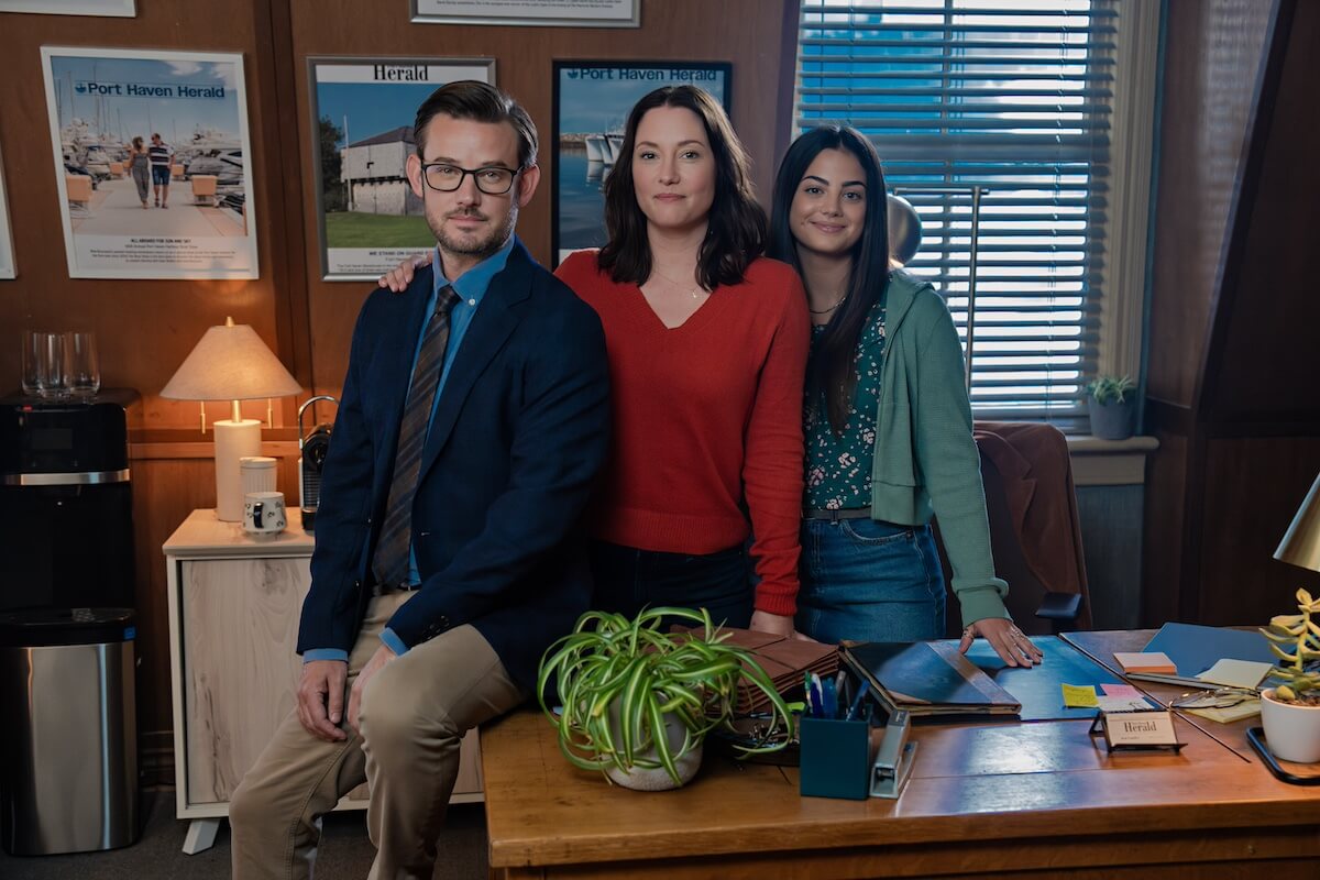Elliot, Kat, and Alice standing behind a desk in 'The Way Home'