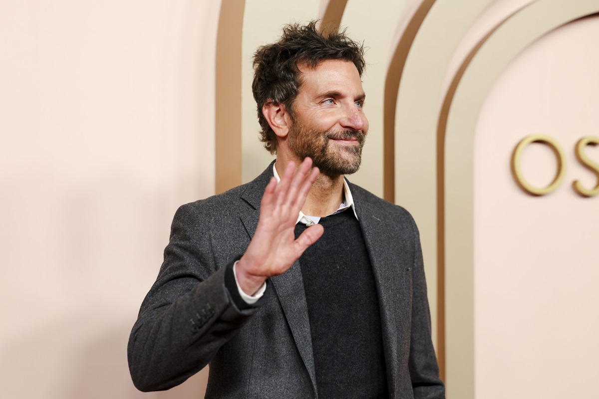 Bradley Cooper posing in a black suit.