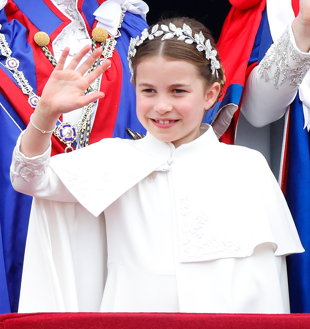 Princess Charlotte of Wales watches an RAF flypast from the balcony of Buckingham Palace following the Coronation of King Charles III and Queen Camilla at Westminster Abbey