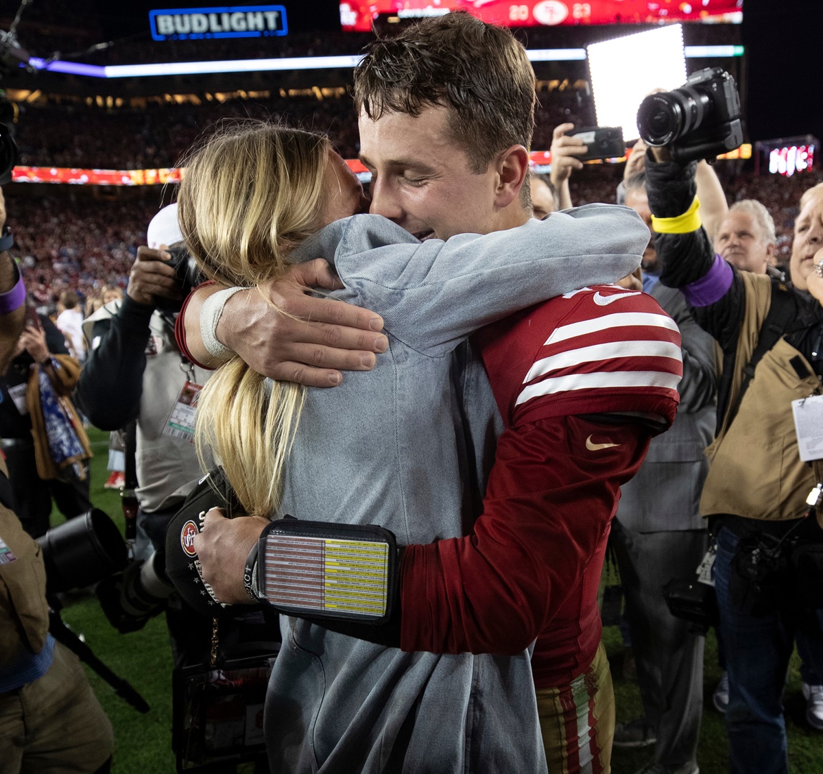 Brock Purdy #13 of the San Francisco 49ers celebrates with his fiancee on the field after the NFC Championship game against the Detroit Lions at Levi's Stadium on January 28, 2024 in Santa Clara, California. The 49ers defeated the Lions 34-31.