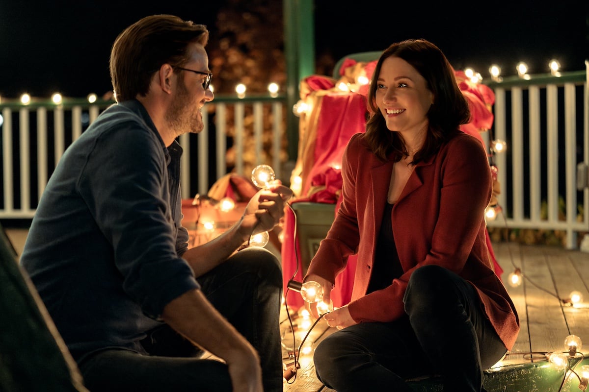 Elliot and Kat sitting in a gazebo surrounded by twinkly lights in 'The Way Home' Season 2