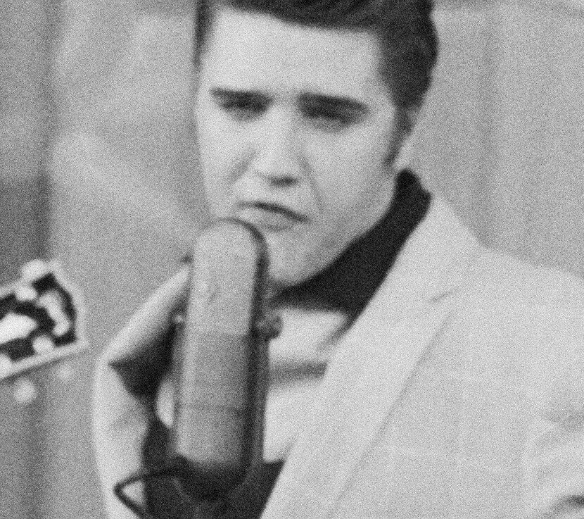 "Rubberneckin'" singer Elvis Presley with a microphone