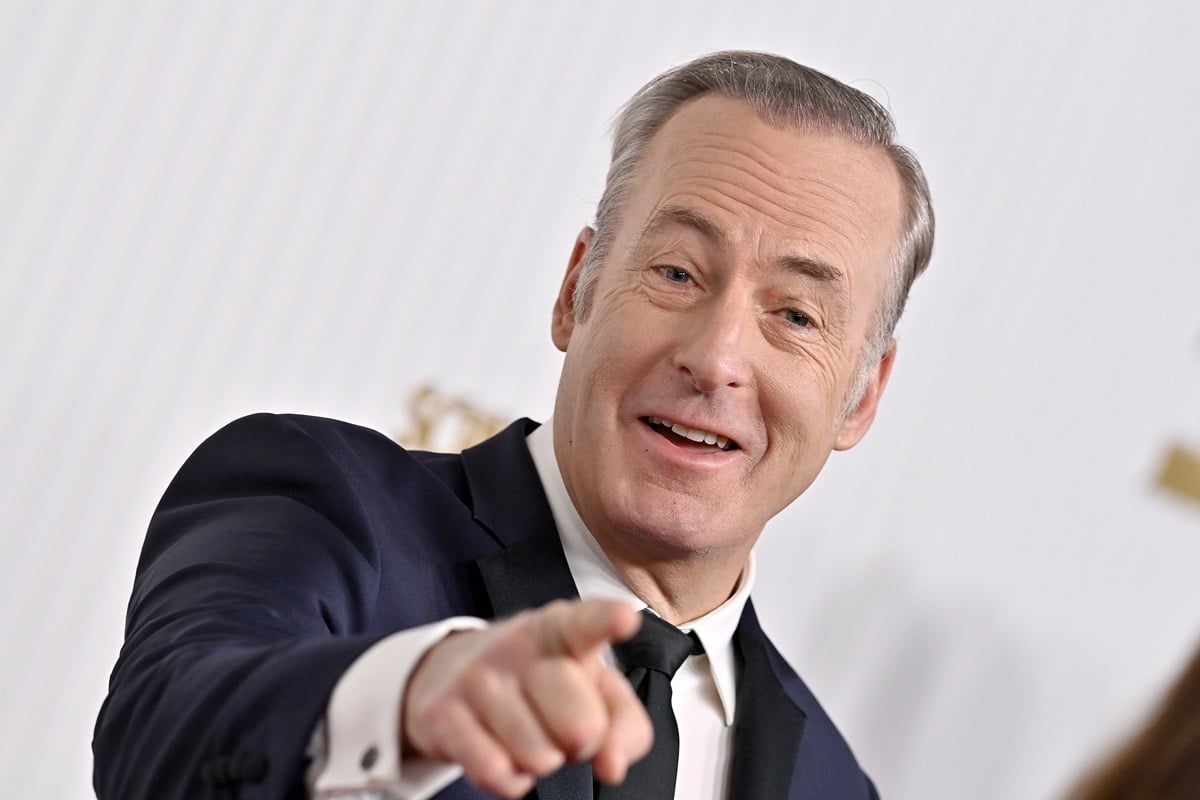 Bob Odenkirk pointing at the camera while wearing a suit.