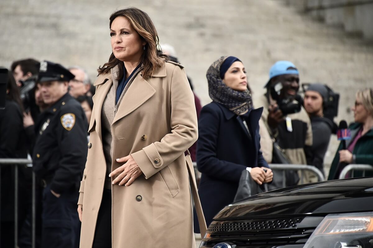 Mariska Hargitay posing on the set of 'Law & Order SVU' wearing a tan trench coat.