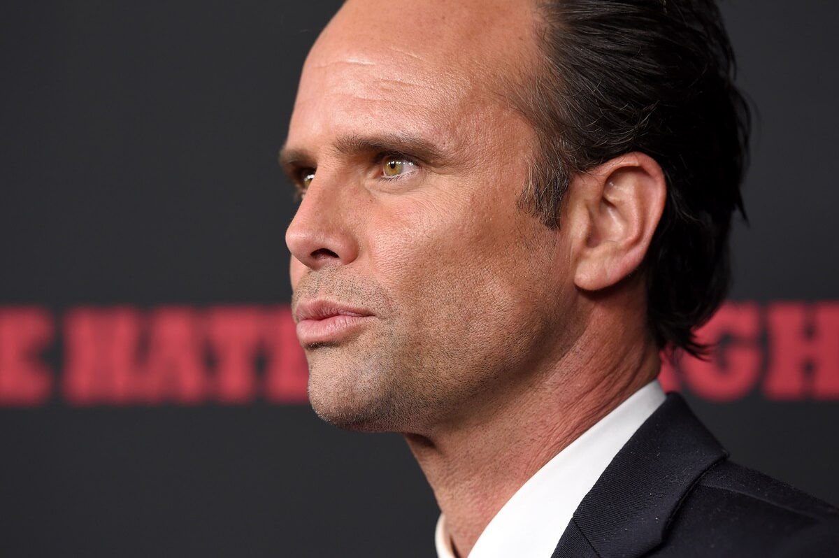 Walter Goggins posing in a suit at the Los Angeles Premiere of 'The Hateful Eight'.