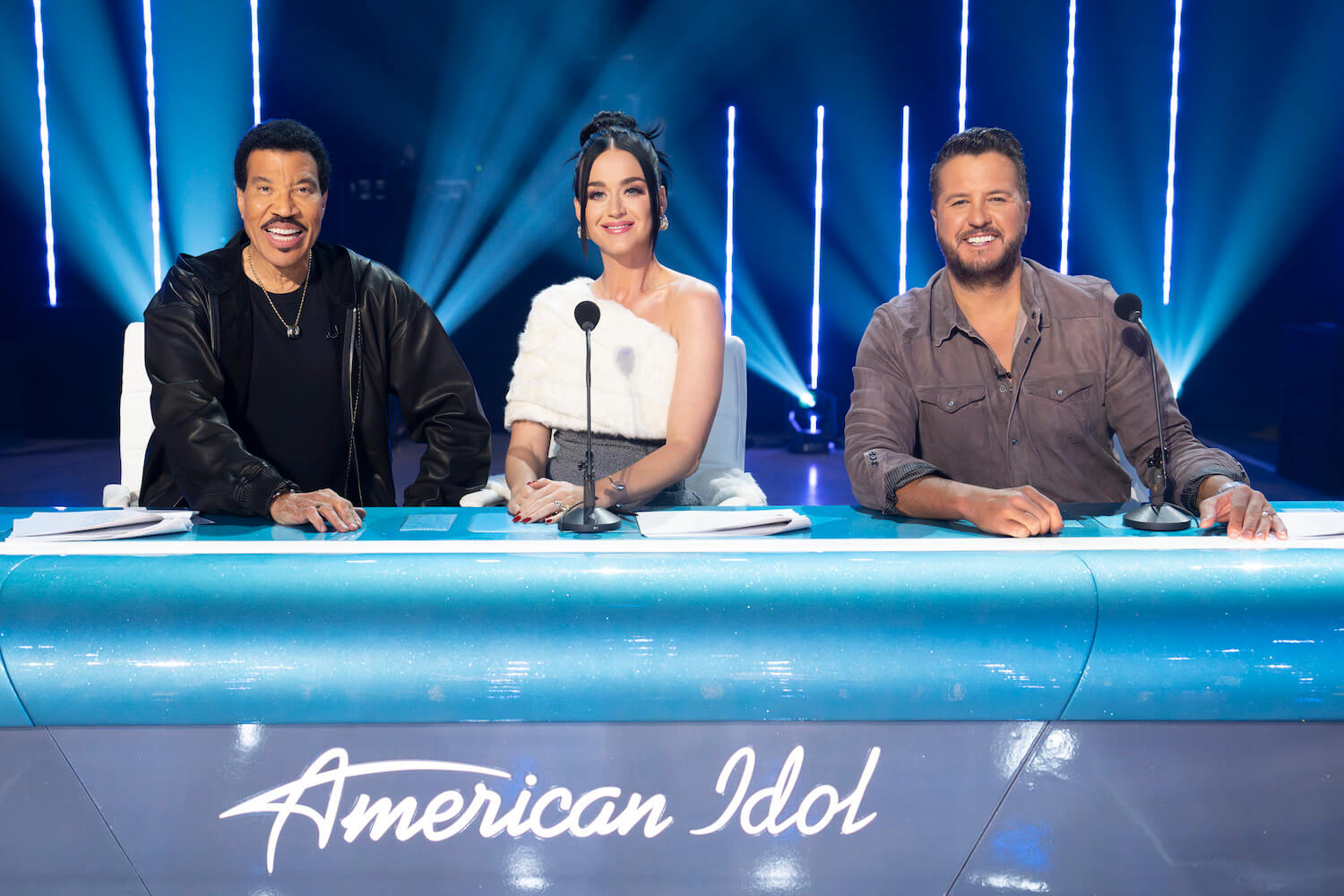Lionel Richie, Katy Perry, and Luke Bryan sitting at the 'American Idol' Season 22 judges table 