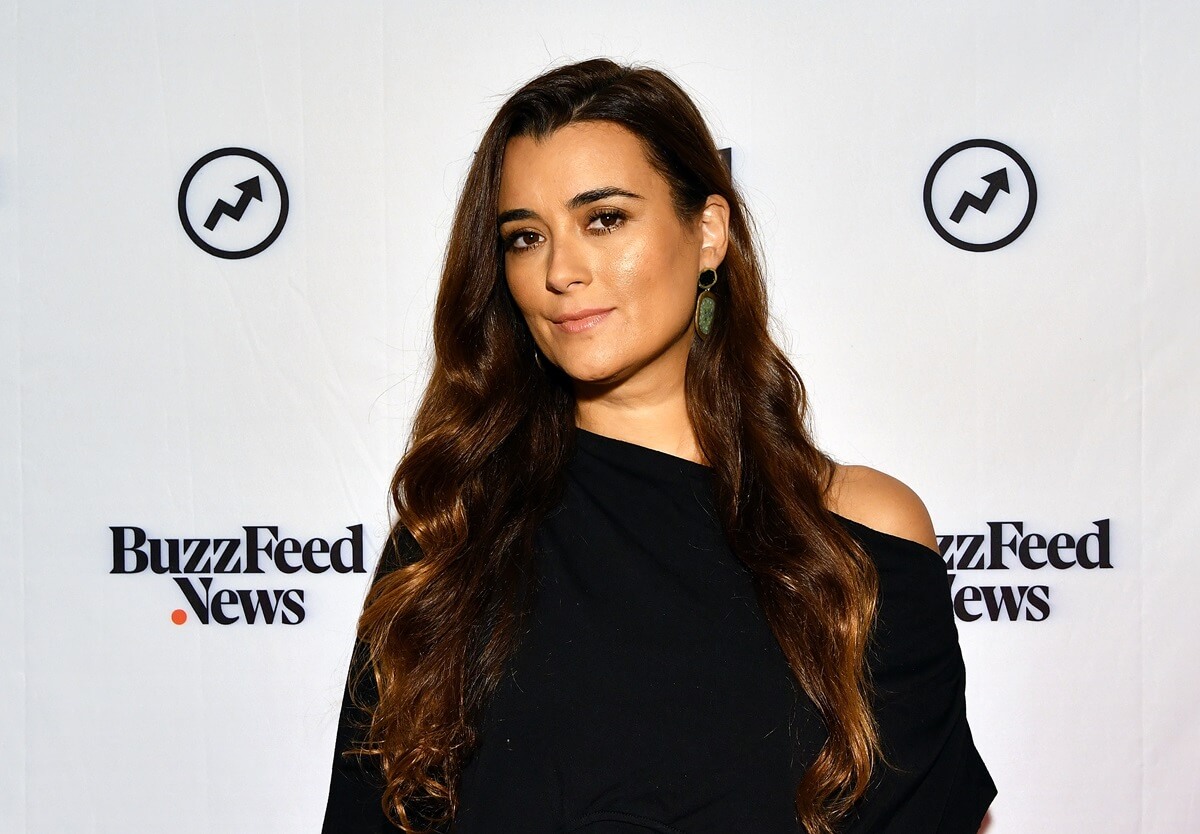 Cote de Pablo posing at Buzzfeed's BuzzFeed's "AM To DM" in a black dress.