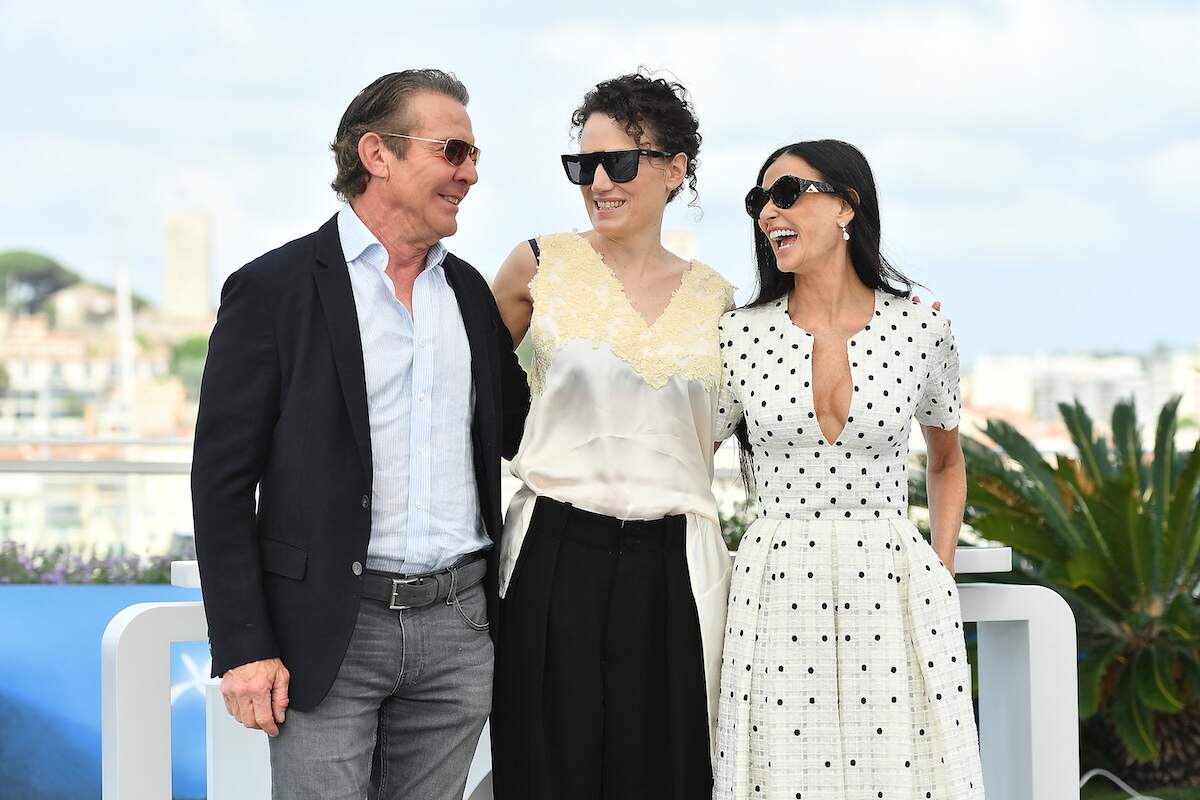 Actor Dennis Quaid, Coralie Fargeat, and Demi Moore laugh together at the "The Substance" Photocall