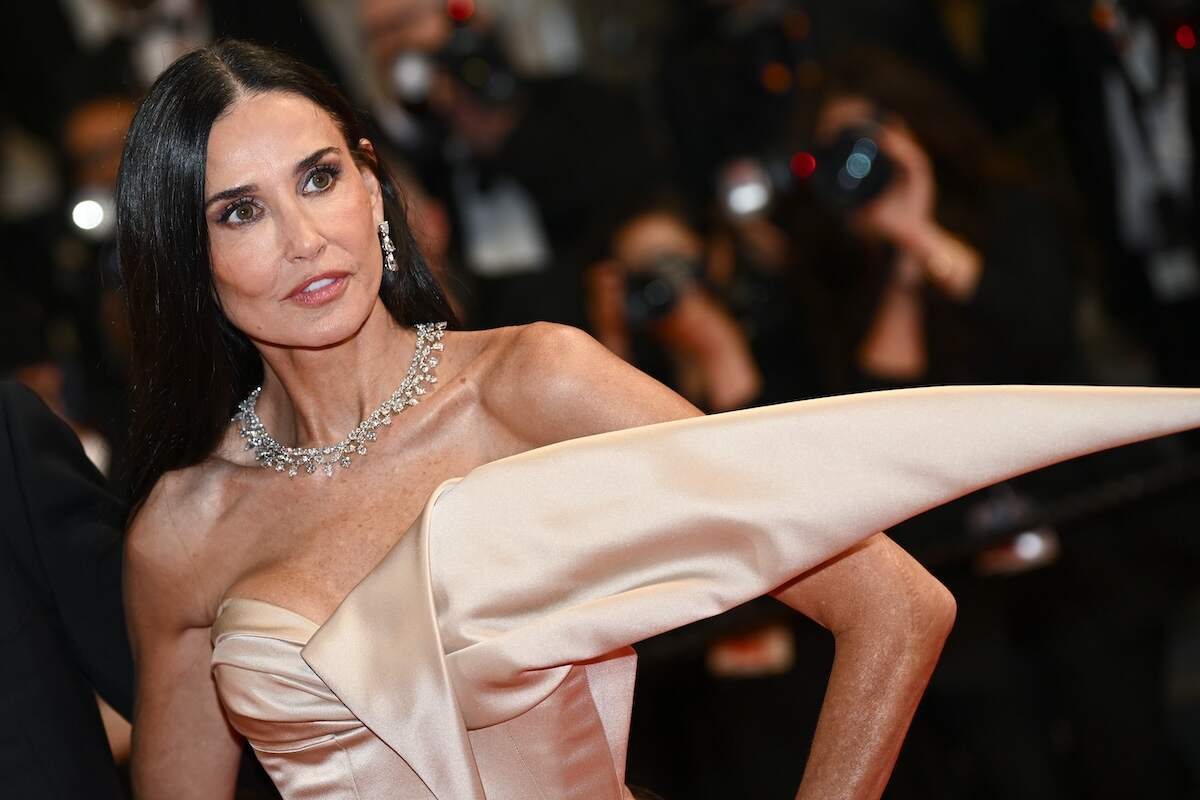 Actor Demi Moore wears a beige satin dress on the red carpet for the 'The Substance Red Carpet