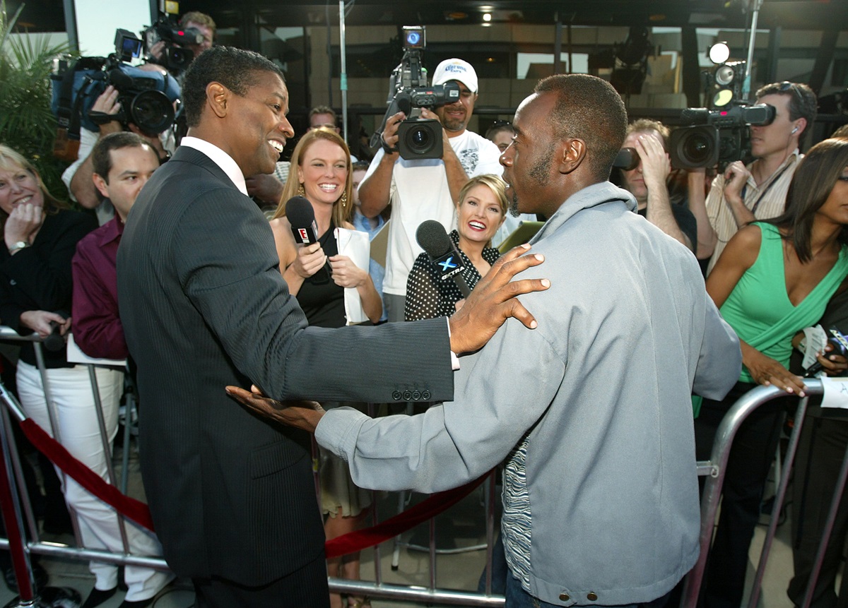 Don Cheadle and Denzel Washington holding each other's arms.