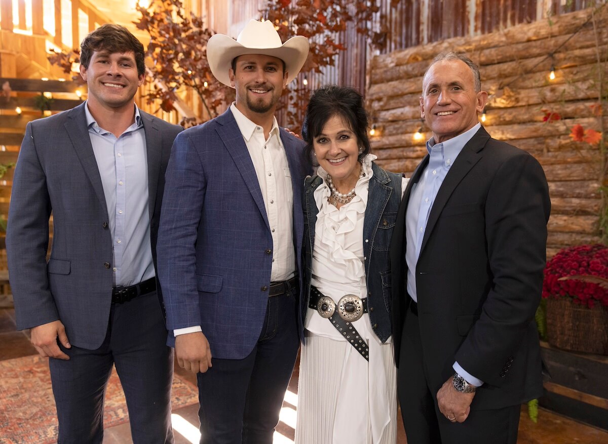 Houston and Mitchell, wearing a cowboy hat, pose with Mitchell's parents in an episode of 'Farmer Wants a Wife' Season 2