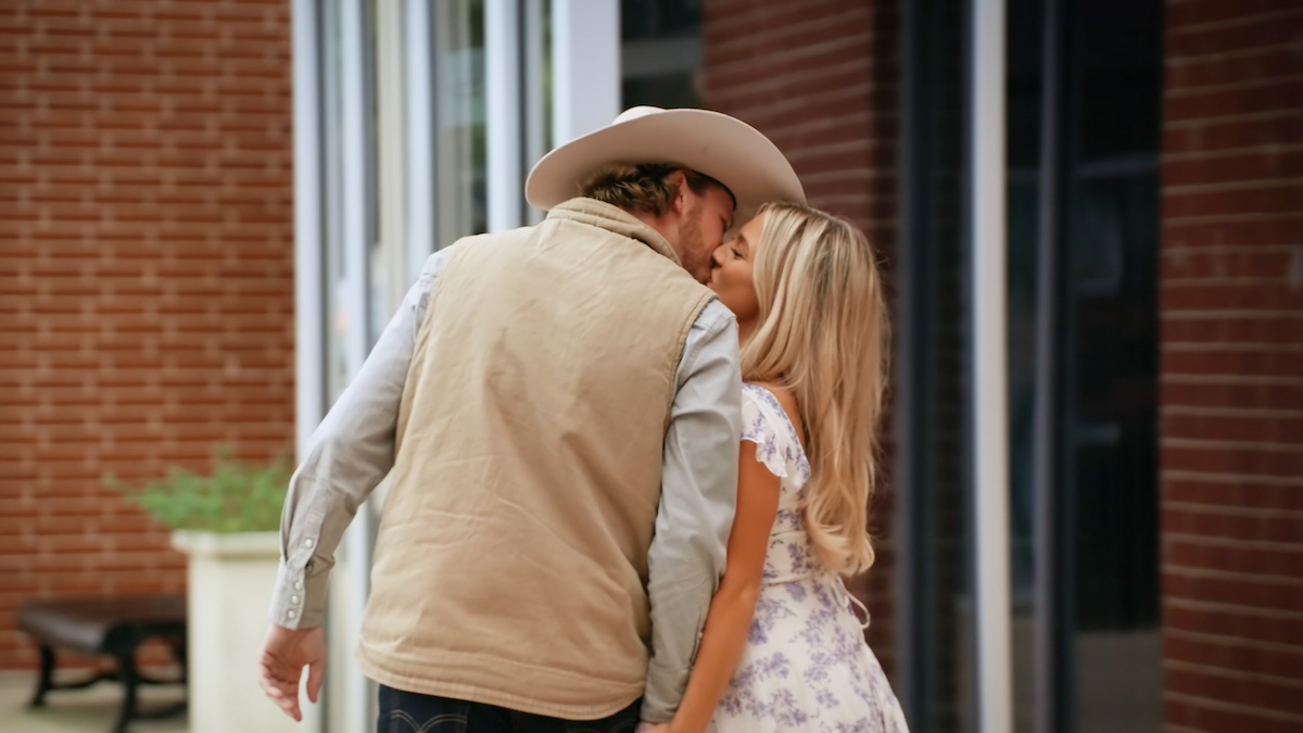 Nathan and Taylor with their backs to the camera and kissing in 'Farmer Wants a Wife'