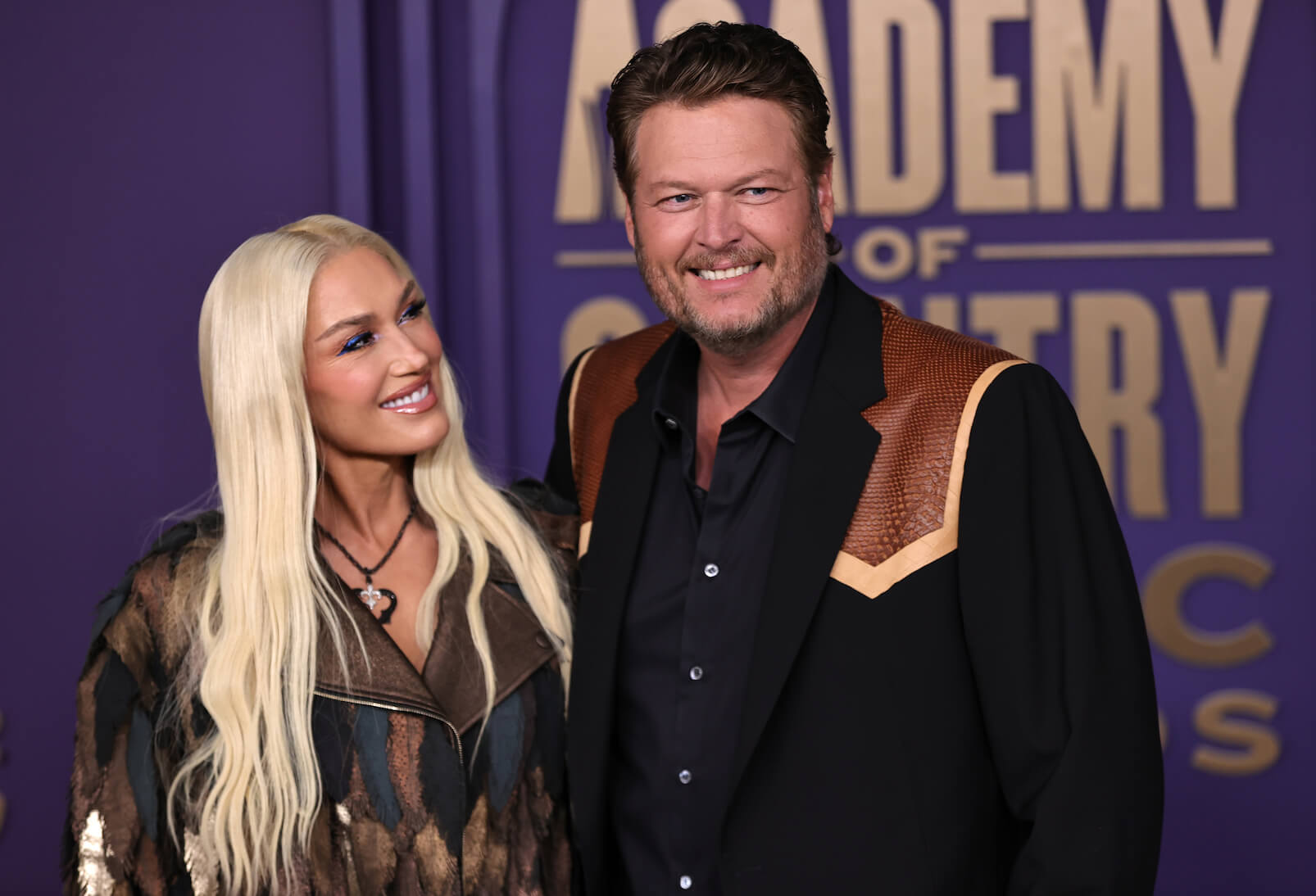 Gwen Stefani smiling and looking at Blake Shelton at the 59th Academy of Country Music Awards at the Omni Frisco Hotel.