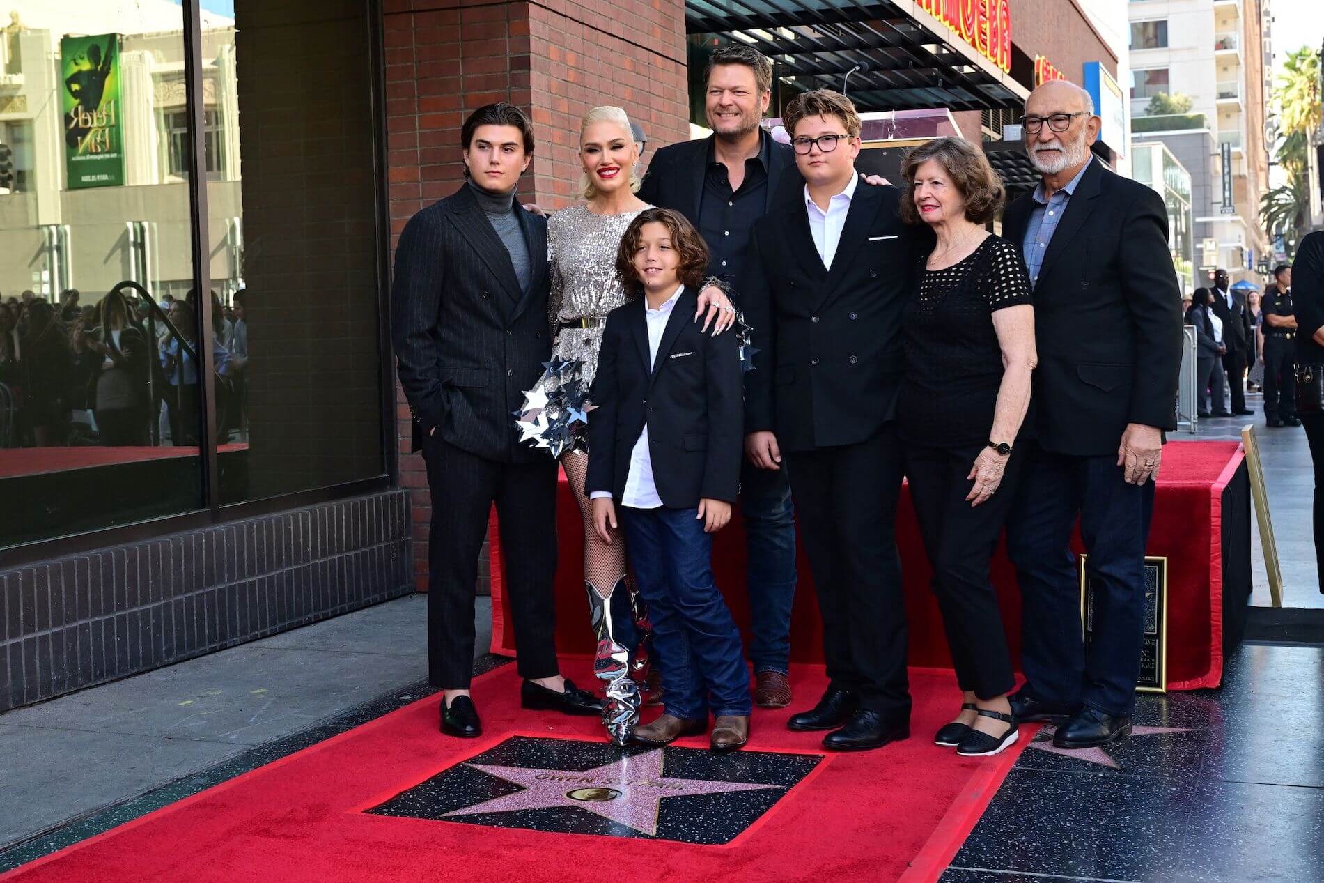 Gwen Stefani and Blake Shelton posing on the Hollywood Walk of Fame with Stefani's three kids, Apollo, Zuma, and Kingston, and Stefani's parents, Patti Flynn and Dennis Stefani