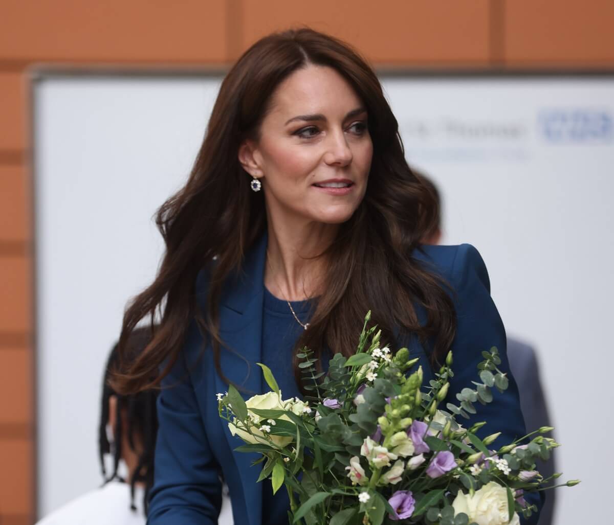 Kate Middleton is seen holding a bouquet of flowers during the opening of Evelina London's new children's day surgery unit