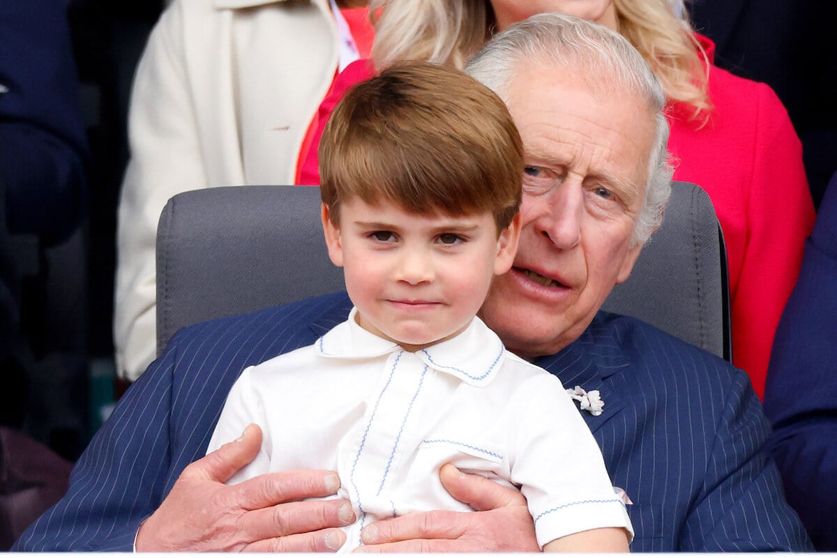 King Charles, who dotes on Prince George, Princess Charlotte, and Prince Louis to compensate for not seeing Prince Archie and Princess Lilibet, per a commentator sits with Prince Louis on his lap 