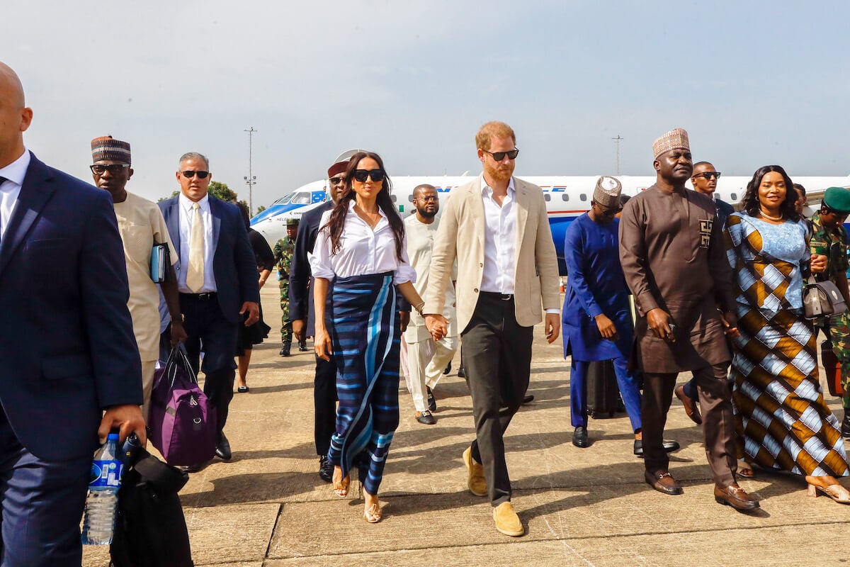 Meghan Markle, who called memories the 'best souvenir' from visiting Nigeria, holds hands with Prince Harry in Nigeria