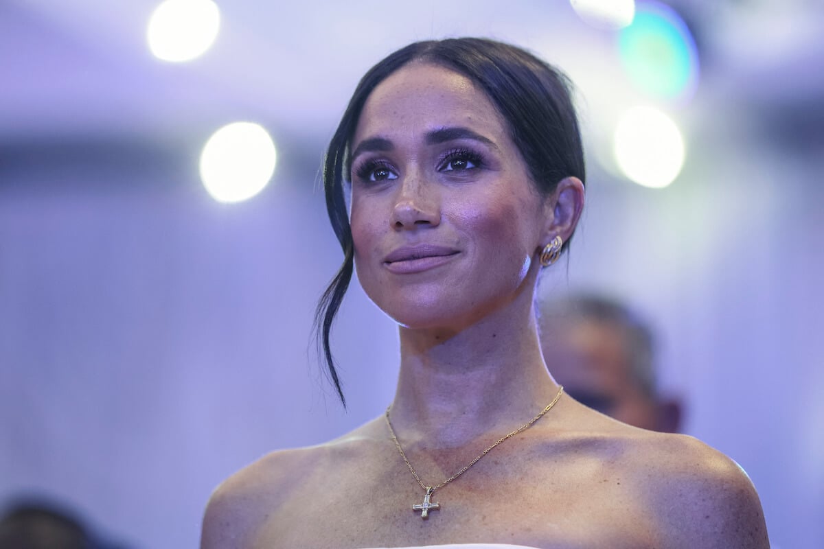 Meghan Markle, whose royal wedding makeup Daniel Martin got 'dragged' for, looks on wearing a white strapless dress in Nigeria