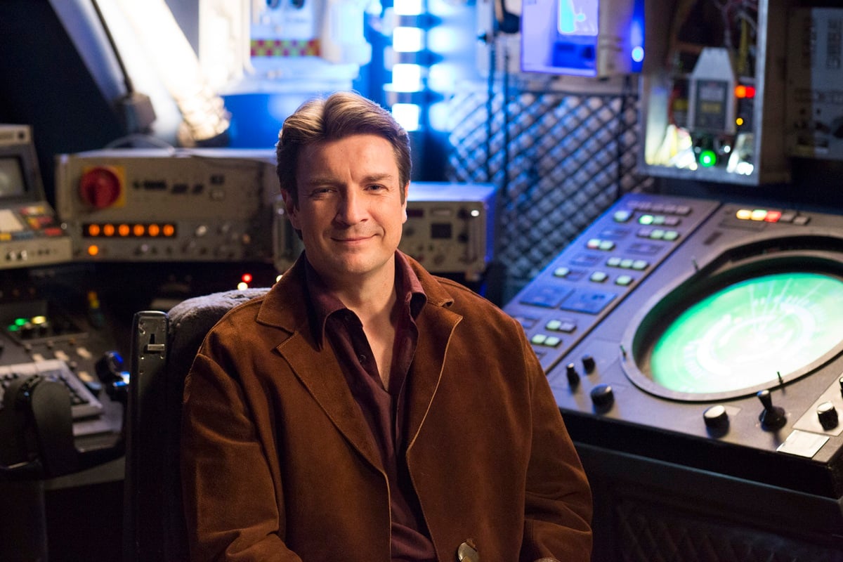 Nathan Fillion posing in an episode of 'American Hosuewife' as his 'Firefly' character.