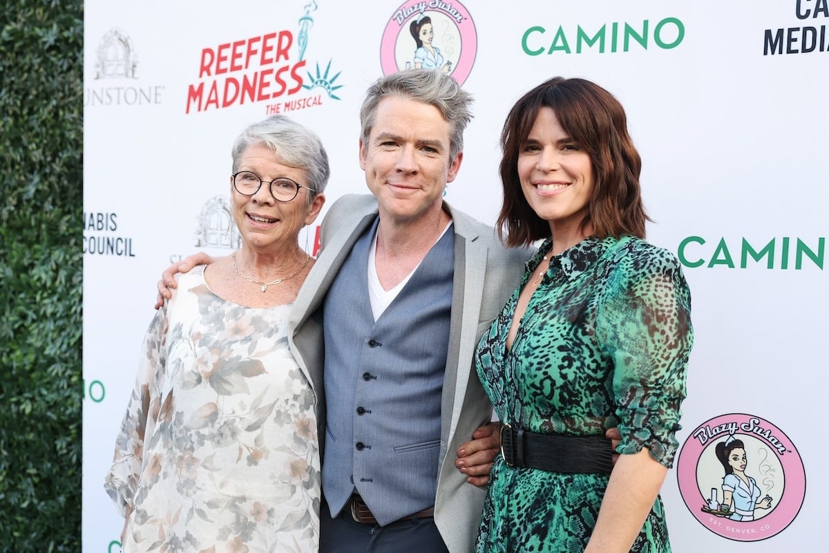 Neve Campbell, her mom, and her husband stand together for a photo at the opening of Reefer Madness