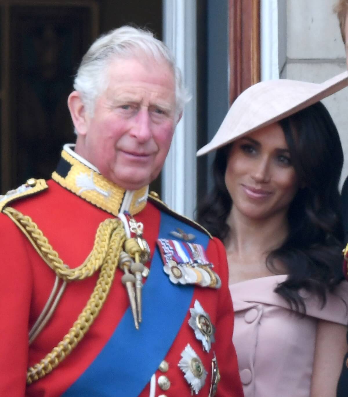Now-King Charles and Meghan Markle standing on the balcony of Buckingham Palace during Trooping The Colour 2018