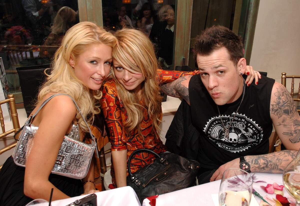 Friends Paris Hilton, Nicole Richie and Joel Madden put their arms around each other and smile at a dinner in 2007