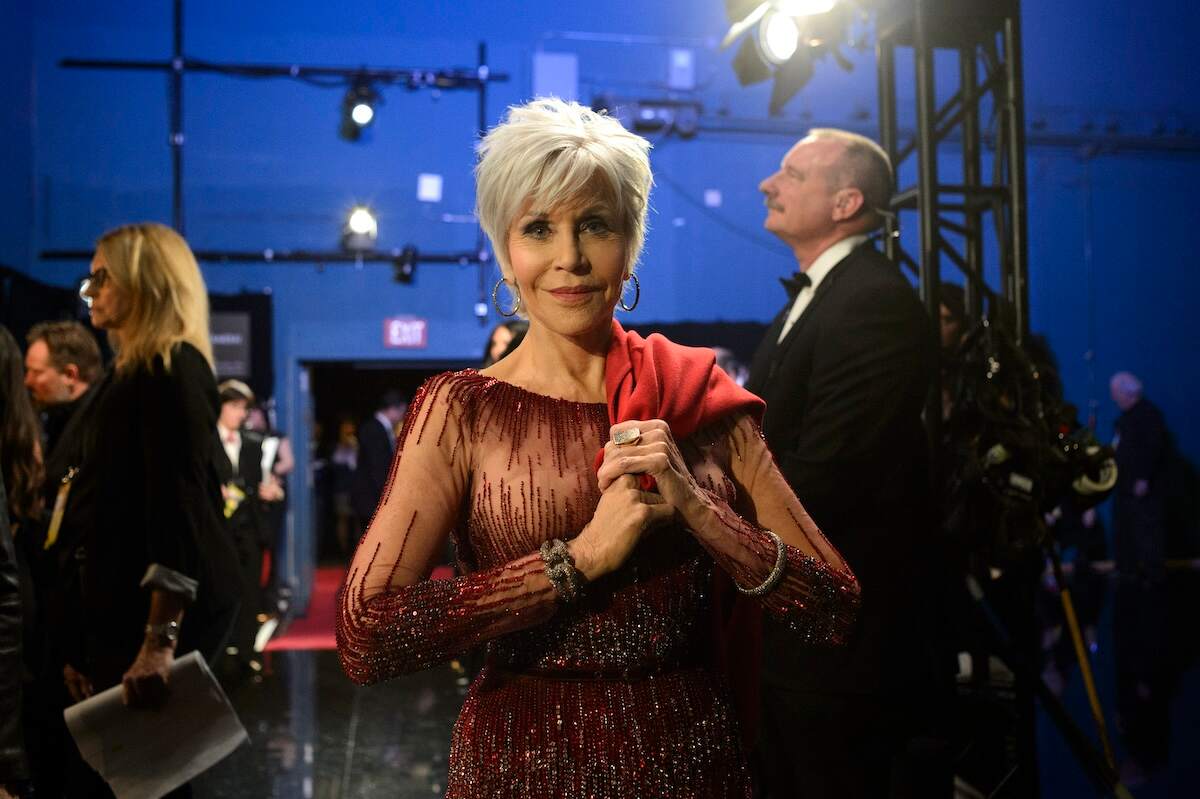 Actor Jane Fonda stands backstage at the 2020 Oscars in a red gown