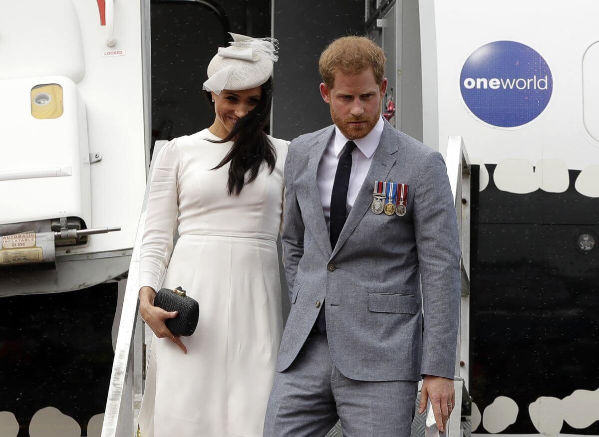 Prince Harry and Meghan Markle disembark from their plane on their arrival in Suva, Fiji